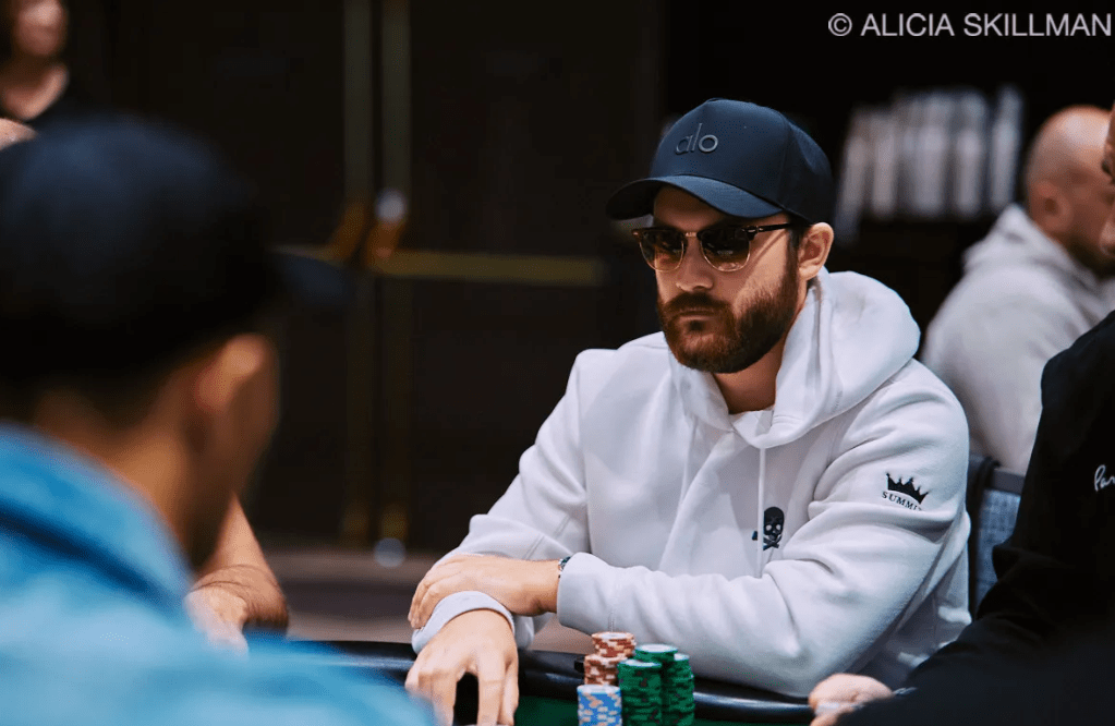 René-Charles Angélil, Celine Dion's son, playing poker at the WSOP 2025 in a white hoodie and sunglasses.