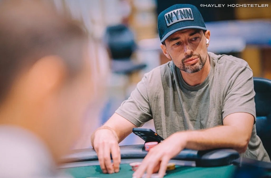 Vincent Moscati sits at the poker table in a gray t-shirt and dark cap, focused as he plays deep in the WSOP Mystery Bounty event.