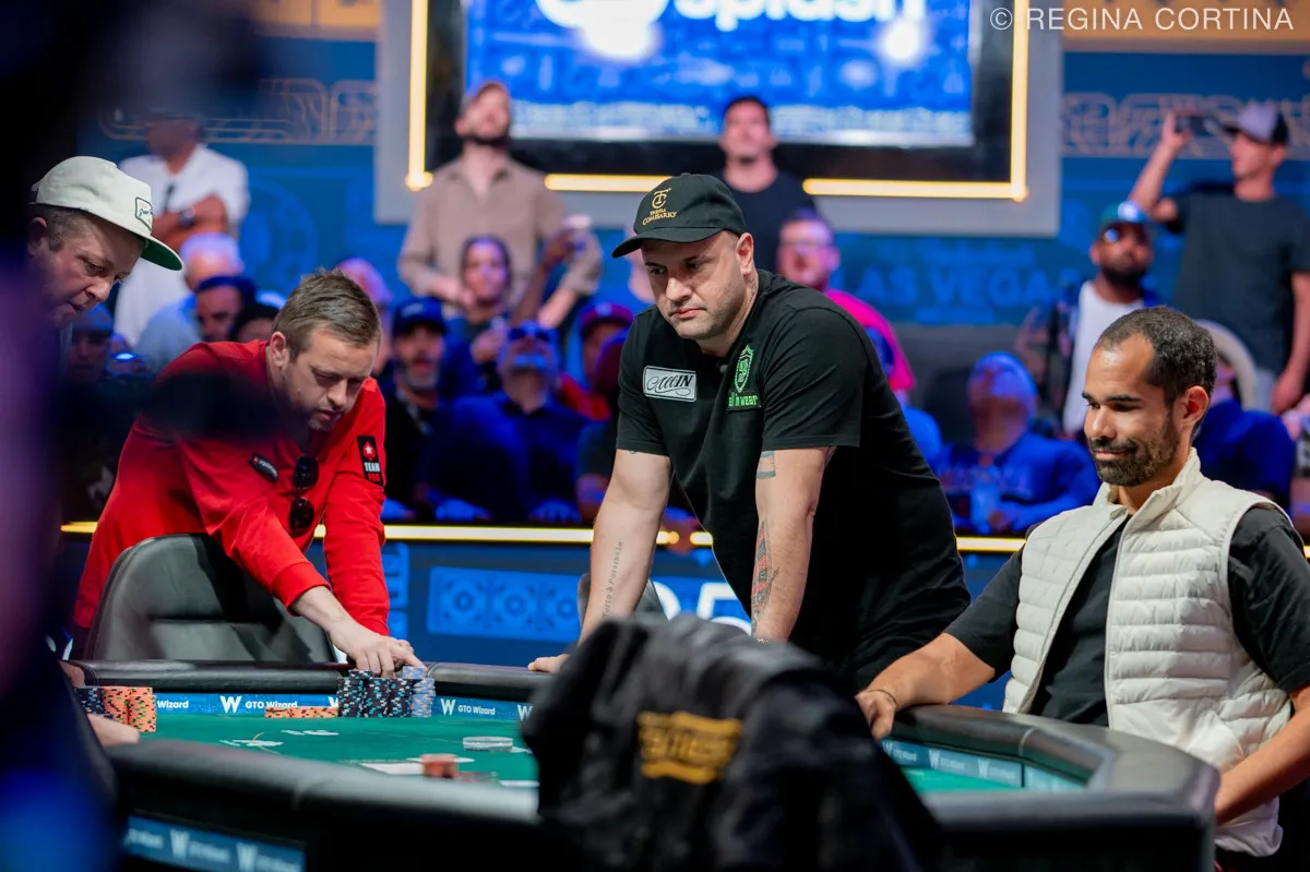 Michael Mizrachi and Kenny Hallaert playing at the WSOP 2025 Main Event final table, with spectators watching in the background.